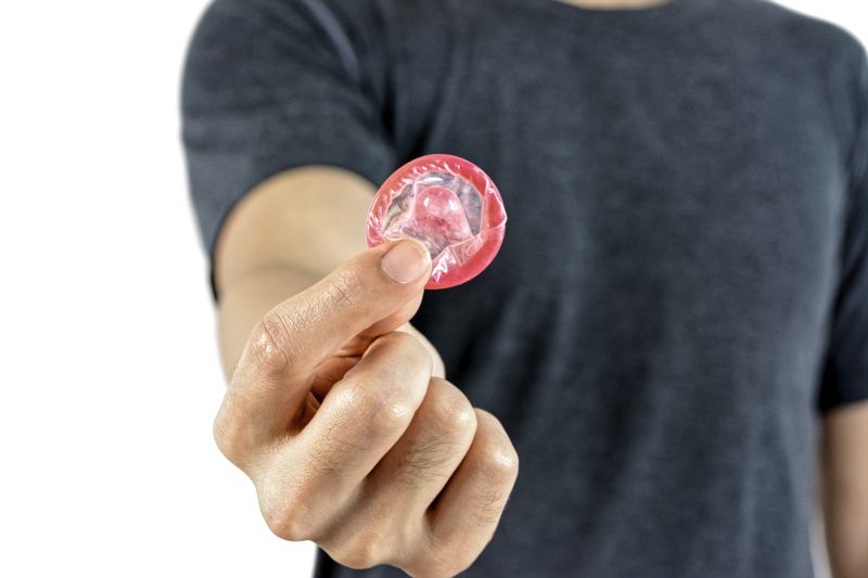 Young man giving condom